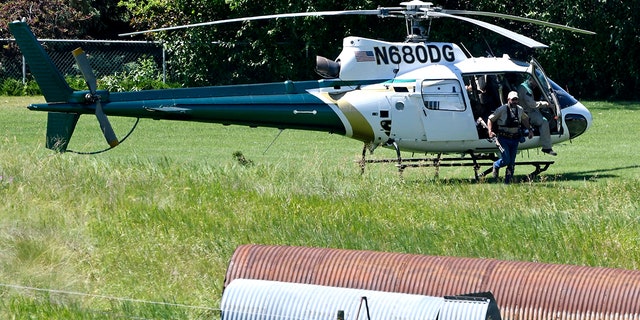 A Montana Department of Fish, Wildlife and Parks helicopter lands in Ovando, Mont., on Tuesday, July 6, 2021, after searching for a bear that killed a camper early that morning. (Tom Bauer/The Missoulian via AP)