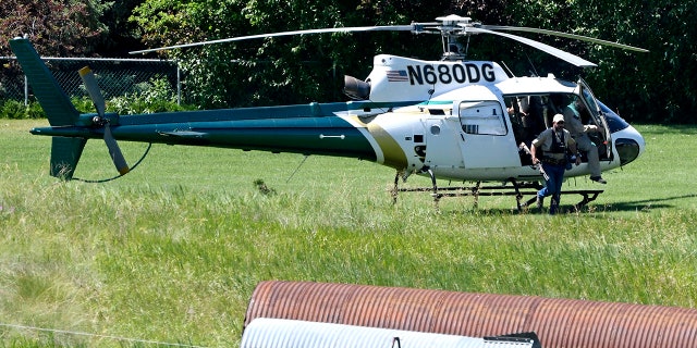 A Montana Department of Fish, Wildlife and Parks helicopter lands in Ovando, Mont., on Tuesday, July 6, 2021, after searching for a bear that killed a camper early that morning. (Tom Bauer/The Missoulian via AP)