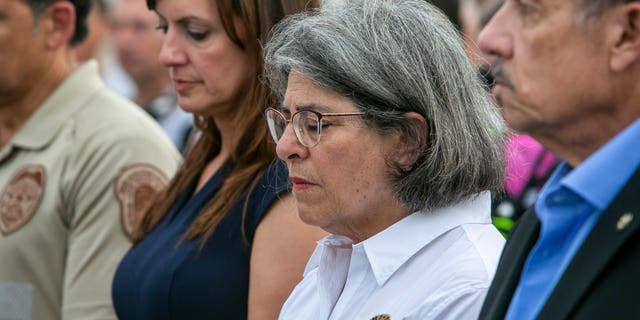 Miami-Dade County Mayor, Daniella Levine Cava, center, stands with other officials in from of the rubble that once was Champlain Towers South in Surfside, Fla., Wednesday, July 7, 2021. (Jose A Iglesias/Miami Herald via AP)