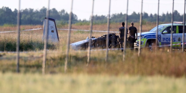 Emergency services at the scene of small aircraft crash at Orebro Airport in Sweden, Thursday, July 8, 2021. The airplane was used by the local parachute club with nine people on board. According to the police, multiple fatalites were reported. (Jeppe Gustafsson/TT News Agency via AP)