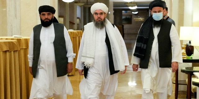 Members of political delegation from the Afghan Taliban's movement Suhil Shaheen, left, Mawlawi Shahabuddin Dilawar, center, and Dr, Mohammad Naim, arrive to attend a news conference in Moscow, Russia, Friday, July 9, 2021. (AP Photo/Alexander Zemlianichenko)