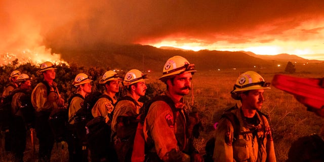 Firefighters from Cal Fire's Placerville station monitor the Sugar Fire, part of the Beckwourth Complex Fire, in Doyle, Calif., on Friday, July 9, 2021. (AP Photo/Noah Berger)