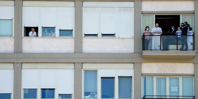 Pope Francis appears on a balcony of the Agostino Gemelli Polyclinic in Rome, Sunday, July 11, 2021, where he is recovering from intestinal surgery, for the traditional Sunday blessing and Angelus prayer. Pope Francis is 84 and had a part of his colon removed a week ago. (AP Photo/Alessandra Tarantino)