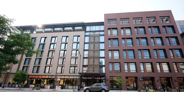 A vehicle sits in the cargo area outside the Maven Hotel on Sunday, July 11, 2021, in lower downtown Denver.  Authorities said four people were arrested for drug and arms trafficking after a "reporting of a suspicious event" at the downtown Denver hotel, located near Coors Field, the site of the 2021 Major League Baseball All-Star Game.  Denver Police said officers responding to a tip searched two rooms in the hotel on Friday night.  (AP Photo / David Zalubowski)