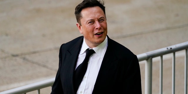 Elon Musk walks from the justice center in Wilmington, Delaware, Monday, July 12, 2021.