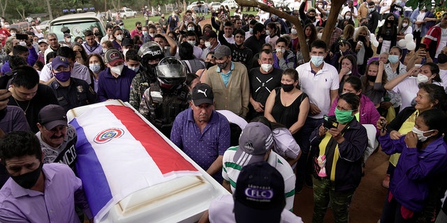 Pallbearers carry the coffin that contain the remains of Leidy Vanessa Luna Villalba outside her home, in Eugenio Garay, Paraguay, Tuesday, July 13, 2021. Luna Villalba, a nanny employed by the sister of Paraguay's first lady Silvana Lopez Moreira, was among those who died in the Champlain Towers South condominium collapse in Surfside, Florida on June 24. (AP Photo/Jorge Saenz)