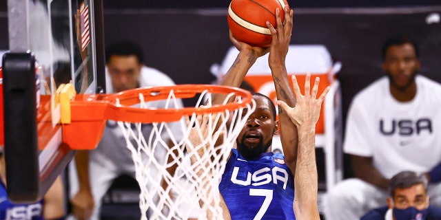 United States' Kevin Durant (7) shoots over Argentina's Patricio Garino during the first half of an exhibition basketball game in Las Vegas on Tuesday, July 13, 2021. (Chase Stevens/Las Vegas Review-Journal via AP)