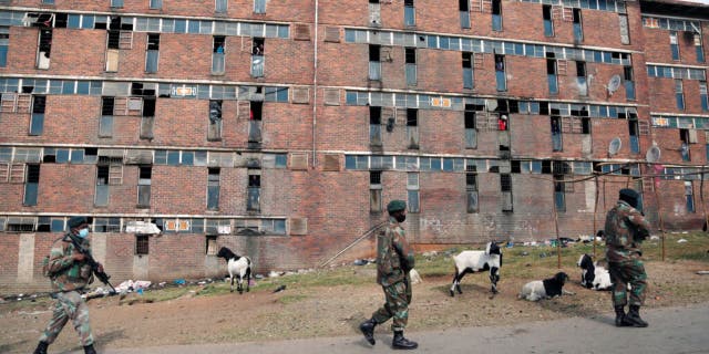 South African Defence Force soldiers on patrol alongside the male single sex hostels in Alexandra Township, north of Johannesburg, Thursday, July 15 2021. 