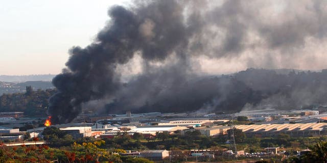 A building burns near Durban South Africa, Thursday, July 15, 2021, as unrest continues in the KwaZulu Natal province. 