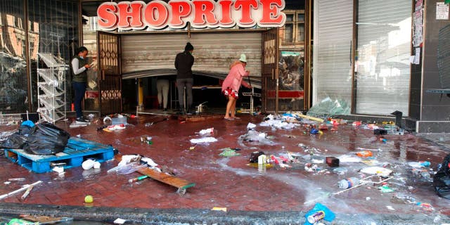 The trashed entrance to a supermarket in Durban South Africa, Thursday, July 15, 2021, as unrest continues in the KwaZulu Natal province.