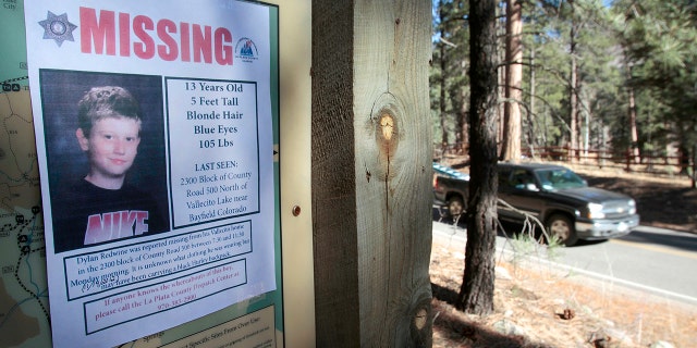 A missing poster of 13-year-old Dylan Redwine hangs on a trail head sign next to Vallecito Reservoir in Vallecito, Colorado, Nov. 26, 2012.