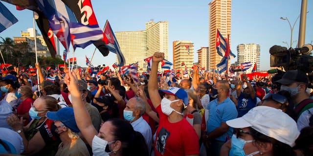 People attend a cultural-political event on the seaside Malecon Avenue with thousands of people in a show of support for the Cuban revolution six days after the uprising of anti-government protesters across the island, in Havana