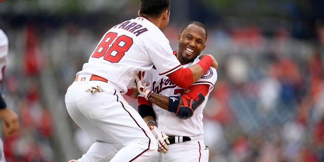 Washington Nationals' Alcides Escobar, right, celebrates his walkoff single that scored Tres Barrera (not shown) with Gerardo Parra (88) during the ninth inning of a baseball game against the San Diego Padres, Sunday, July 18, 2021, in Washington. (AP Photo/Nick Wass)