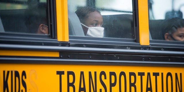 FILE - In this Oct. 12, 2020, file photo, students arrive by bus at Foundation Preparatory School for their return to school in New Orleans. (Chris Granger/The Times-Picayune/The New Orleans Advocate via AP, File)