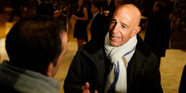 This Tuesday, January 10, 2017 photo shows Tom Barrack speaking with reporters in the lobby of Trump Tower in New York City before meeting with President-elect Donald Trump. 
