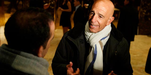 This Tuesday, January 10, 2017 photo shows Tom Barrack speaking with reporters in the lobby of Trump Tower in New York City before meeting with President-elect Donald Trump. 