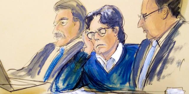 FILE - In this June 18, 2019, file courtroom artist's sketch, defendant Keith Raniere, center, sits with attorneys Paul DerOhannesian, left, and Marc Agnifilo during closing arguments at Brooklyn federal court in New York.