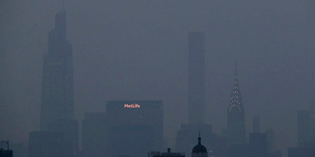 The Met Life and Chrysler buildings glow through a thick haze hanging over Manhattan, Tuesday, July 20, 2021, in New York.