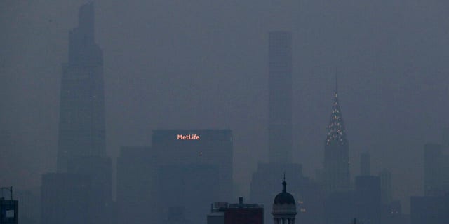 The Met Life and Chrysler buildings glow through a thick haze hanging over Manhattan, Tuesday, July 20, 2021, in New York.