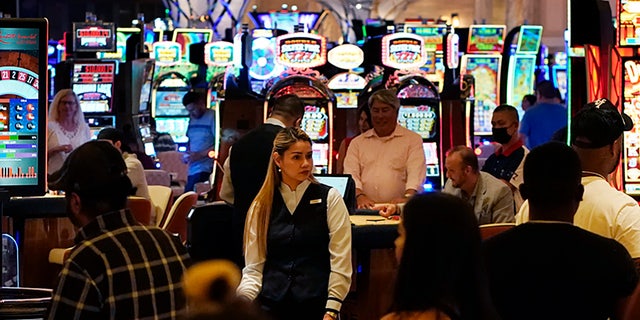 Crowds walk through the casino during the opening night of Resorts World Las Vegas in Las Vegas on June 24, 2021.  (AP Photo/John Locher, File)