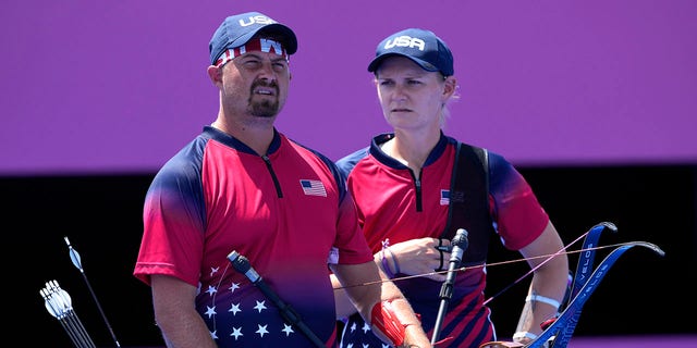 United States' Brady Ellison, left, and his teammate Mackenzie Brown react during the mixed team competition against Indonesia at the 2020 Summer Olympics, Saturday, July 24, 2021, in Tokyo, Japan. (AP Photo/Alessandra Tarantino)