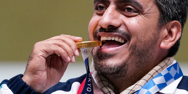 Javad Foroughi, of Iran, celebrates after winning the gold medal in the men's 10-meter air pistol at the Asaka Shooting Range in the 2020 Summer Olympics, Saturday, July 24, 2021, in Tokyo, Japan. (AP Photo/Alex Brandon)
