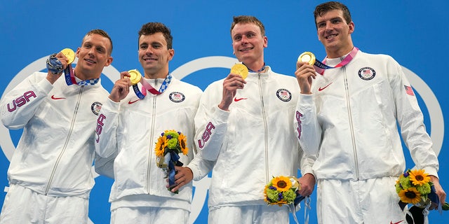 The US 4x100m freestyle relay team of Caeleb Dressel, Blake Pieroni, Bowen Beck and Zach Apple, celebrates with their medals after winning the gold medal at the 2020 Summer Olympics on Monday, July 26, 2021, in Tokyo.  (Associated press)