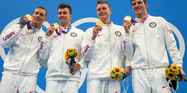 The US 4x100m freestyle relay team of Caeleb Dressel, Blake Pieroni, Bowen Beck and Zach Apple, celebrates with their medals after winning the gold medal at the 2020 Summer Olympics on Monday, July 26, 2021, in Tokyo.  (Associated press)