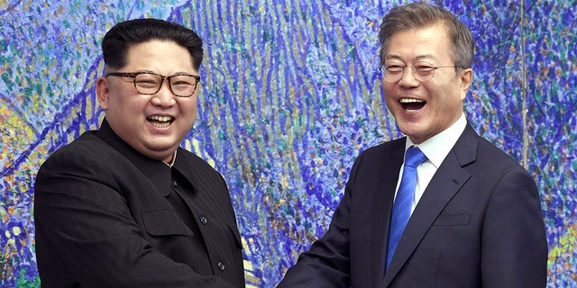 North Korean leader Kim Jong Un, left, poses with South Korean President Moon Jae-in for a photo inside the Peace House at the border village of Panmunjom in Demilitarized Zone, South Korea on April 27, 2018.  (Korea Summit Press Pool via AP, File)