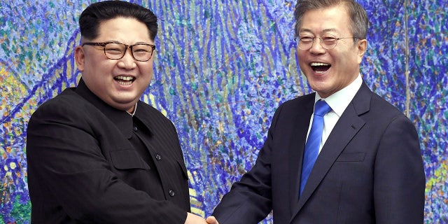 North Korean leader Kim Jong Un, left, poses with South Korean President Moon Jae-in for a photo inside the House of Peace in the border village of Panmunjom in the Demilitarized Zone, Korea. South, April 27, 2018 (Korea Summit Press Pool via AP, File)
