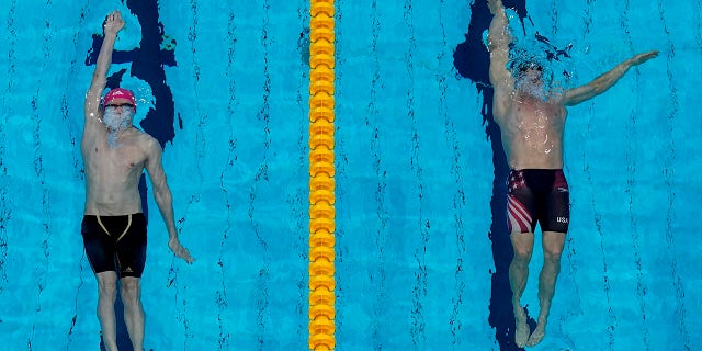 Ryan Murphy, of the United States, and Kliment Kolesnikov, of the Russian Olympic Committee, swim in the final of the men's 100-meter backstroke final at the 2020 Summer Olympics, Tuesday, July 27, 2021, in Tokyo, Japan. (AP Photo/Morry Gash)