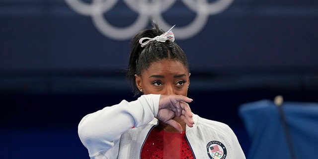 Simone Biles, of the United States, watches gymnasts perform at the 2020 Summer Olympics, Tuesday, July 27, 2021, in Tokyo. 