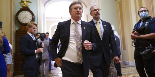 Rep. Thomas Massie, R-Ky., left, Rep. Andy Harris, R-Md., and other conservative members of the House walk to the Senate chamber, as they express their opposition to new mask guidance, at the Capitol in Washington, Thursday, July 29, 2021. Earlier in the day, House Minority Leader Kevin McCarthy, R-Calif., charged that the Centers for Disease Control has become a political arm of the administration. (AP Photo/J. Scott Applewhite)