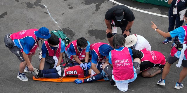 Medics prepare to take Connor Fields of the United States on a stretcher after he crashed at the first turn during the BMX Racing men's semi-finals at the 2020 Summer Olympics on Friday, July 30, 2021, in Tokyo, Japan.  (AP Photo / Ben Curtis)