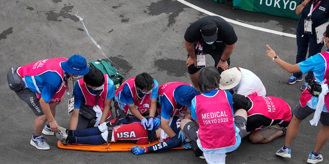 Medics prepare to carry away on a stretcher Connor Fields of the United States after he crashed at the first bend in the men's BMX Racing semifinals at the 2020 Summer Olympics, Friday, July 30, 2021, in Tokyo, Japan. (AP Photo/Ben Curtis)