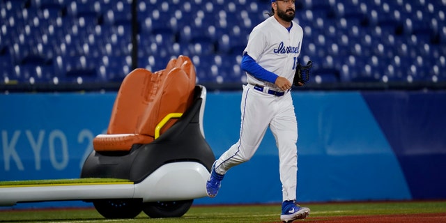 Israel's Shlomo Lipetz (12) comes into the game to pitch against the United State during a baseball game at the 2020 Summer Olympics, Friday, July 30, 2021, in Yokohama, Japan. (AP Photo/Sue Ogrocki)