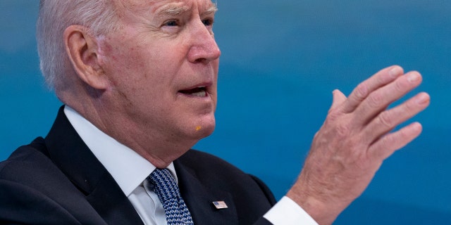 President Biden has something small and yellow on his chin as he speaks during a meeting with governors. (AP Photo/Andrew Harnik)