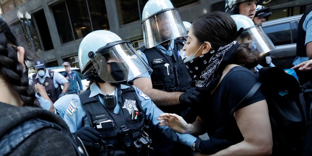 Chicago police officers and protesters clash in a protest against the death of George Floyd in Chicago on Saturday, May 30, 2020.  Floyd died after being arrested and detained by Minneapolis police on Memorial Day in Minnesota.  (AP Photo / Nam Y. Huh)