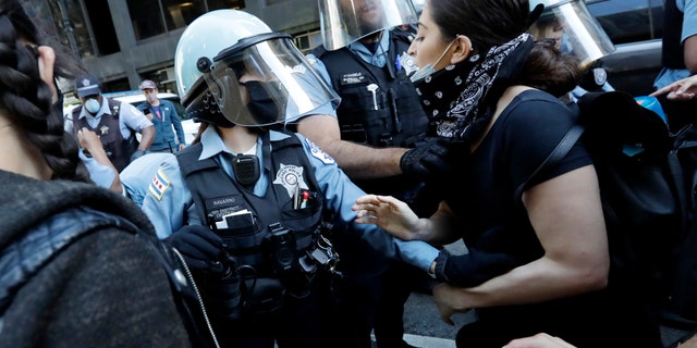 Chicago police officers and protesters clash in a protest against the death of George Floyd in Chicago on Saturday, May 30, 2020.  Floyd died after being arrested and detained by Minneapolis police on Memorial Day in Minnesota.  (AP Photo / Nam Y. Huh)