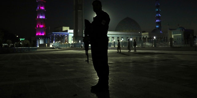 An Afghan security police officer stands guard in the courtyard of Hazrat-e-Ali shrine or Blue Mosque, in the city of Mazar-e-Sharif province north of Kabul, Afghanistan, Wednesday, July 7, 2021. (AP Photo/Rahmat Gul)