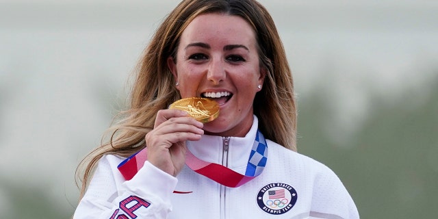 Amber English of the United States celebrates with her gold medal in the women's skeet at the Asaka Shooting Range in the 2020 Summer Olympics, Monday, July 26, 2021, in Tokyo, Japan. (AP Photo/Alex Brandon)