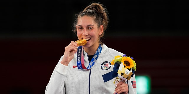 U.S. Olympian Anastasija Zolotic holds her gold medal during a ceremony for the taekwondo women's 57kg at the 2020 Summer Olympics, Sunday, July 25, 2021, in Tokyo. (Associated Press)