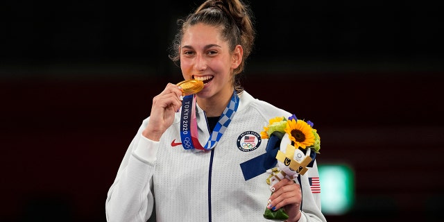 U.S. Olympian Anastasija Zolotic holds her gold medal during a ceremony for the taekwondo women's 57kg at the 2020 Summer Olympics, Sunday, July 25, 2021, in Tokyo. (Associated Press)
