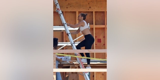 Jennifer Lopez is looking for her new home as a priority as the singer climbs a ladder while exploring a house still under construction.