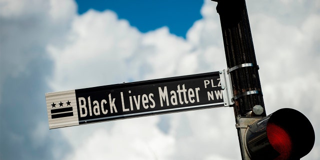 A new street sign that reads "Black Lives Matter Plaza NW" can be seen at the intersection of H and 16th Street near the White House in Washington DC, on June 5, 2020. 