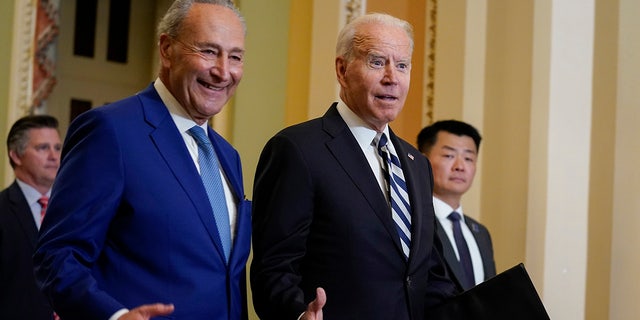 President Joe Biden walks with Senate Majority Leader Chuck Schumer, D-N.Y., at the Capitol in Washington, Wednesday, July 14, 2021, as he arrives to discuss the latest progress on his infrastructure agenda. (AP Photo/Evan Vucci)