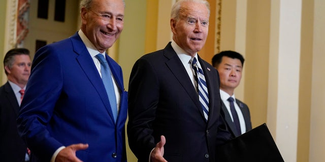 President Joe Biden walks with Senate Majority Leader Chuck Schumer, D-N.Y., July 14, 2021. (AP Photo/Evan Vucci)