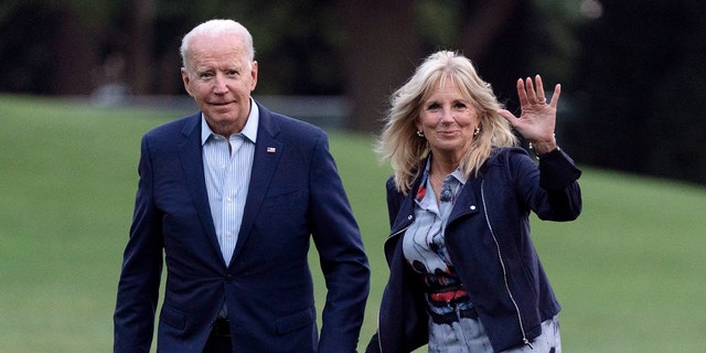 President Joe Biden and first lady Jill Biden walk on the South Lawn of the White House after stepping off Marine One on Sunday.
