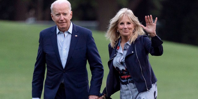 President Joe Biden and first lady Jill Biden walk on the South Lawn of the White House after stepping off Marine One on Sunday.