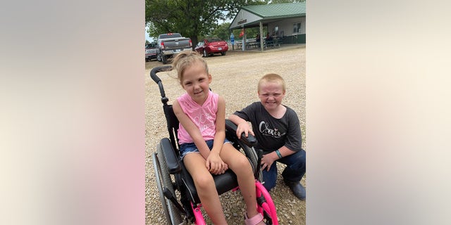 Jesse Starr, 8 (right) helped his friend Claire Calvin (left) who was diagnosed with a brain tumor in 2020, raise money for medical expenses by selling his pet hog.